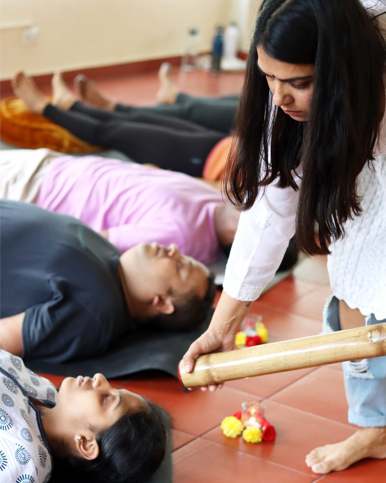 Sound healing with a bamboo instrument over resting participants