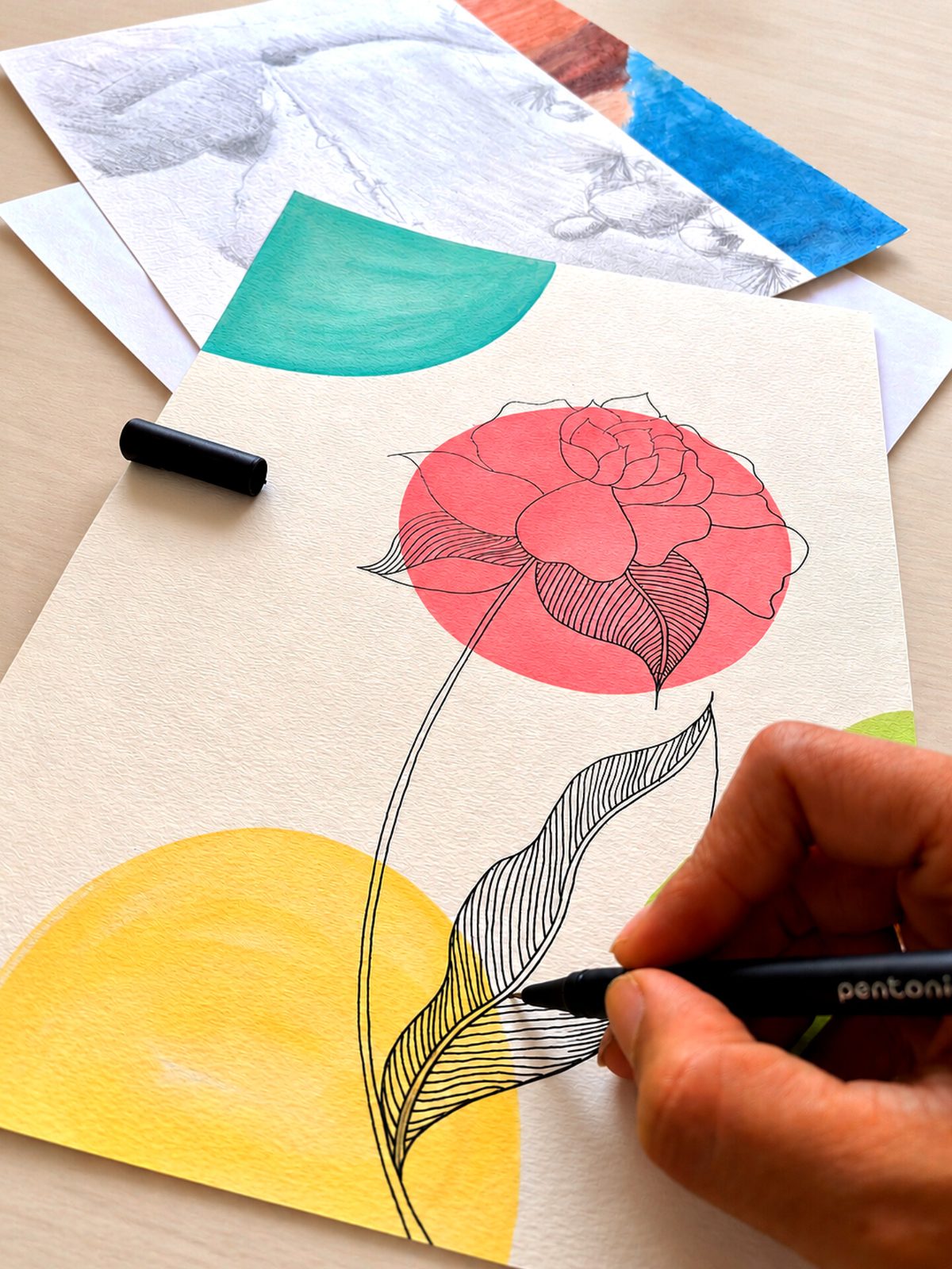 Hand drawing a floral illustration during an art session