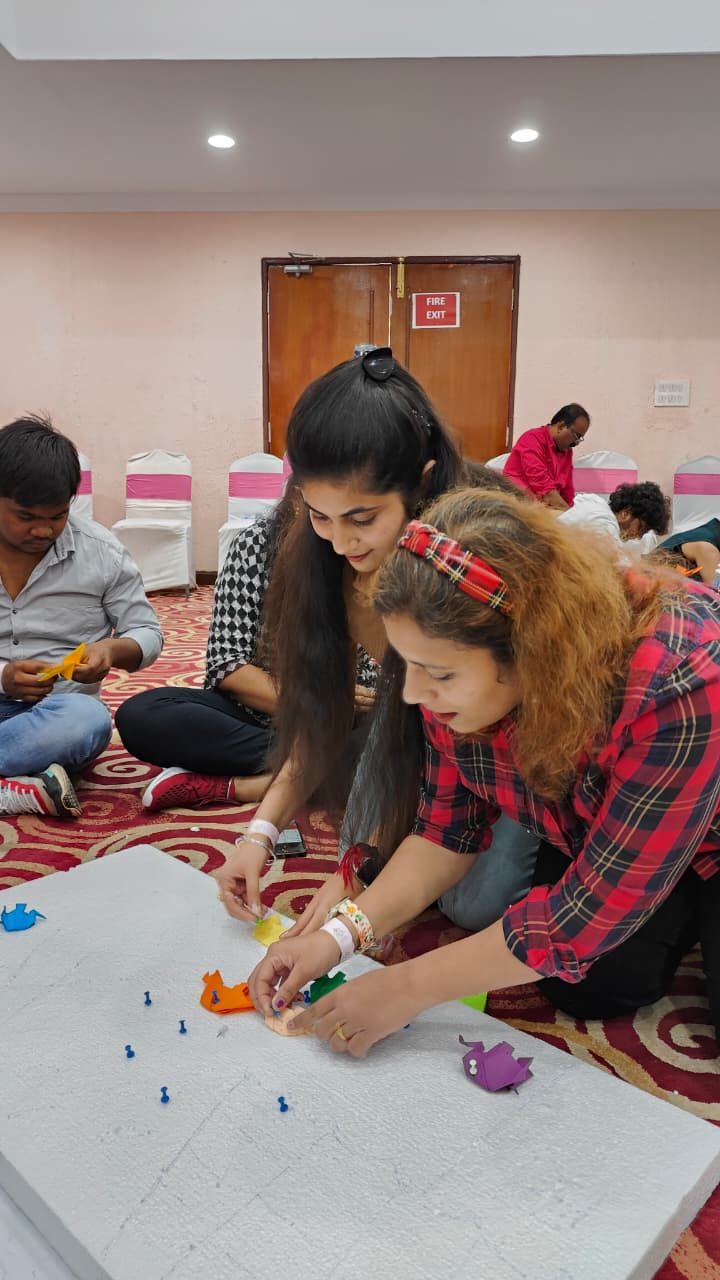 Participants working on a craft activity on the floor